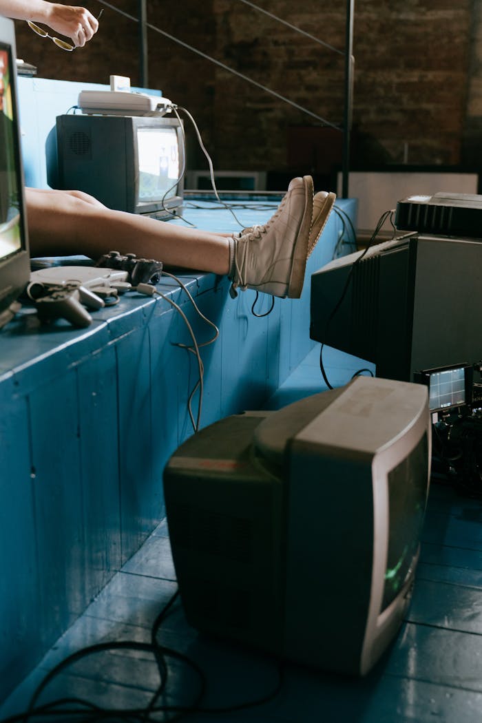 A nostalgic indoor scene of vintage video game consoles and TV screens with a focus on retro aesthetics.